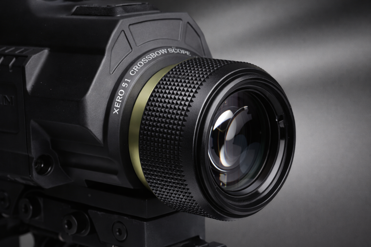 Close-up of Garmin Xero X1i knurled adjustment ring and front lens, studio lighting